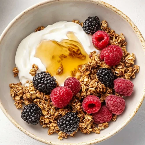Paleo Granola: The Ultimate Grain-Free Crunch You Can Make at Home 3 A bowl of paleo granola with coconut yogurt, fresh berries, and a drizzle of honey.